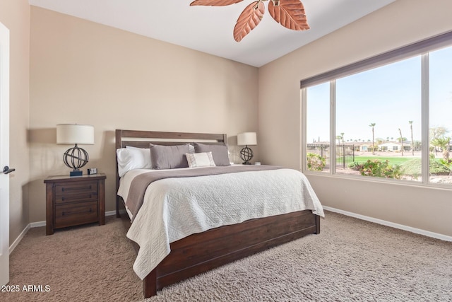 bedroom with carpet, multiple windows, and baseboards