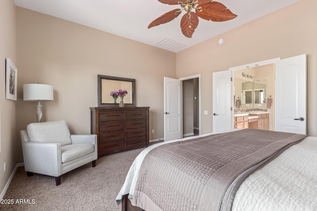 bedroom featuring light carpet, ensuite bath, visible vents, and baseboards