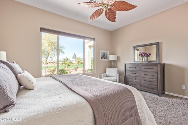 carpeted bedroom with ceiling fan and baseboards