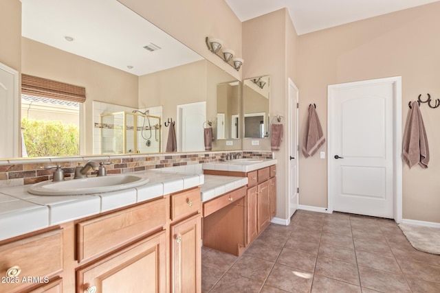 full bath featuring visible vents, tile patterned floors, vanity, a shower stall, and backsplash