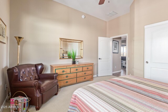 bedroom with light carpet, baseboards, visible vents, and a ceiling fan