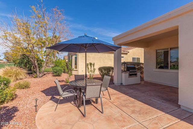 view of patio / terrace featuring a grill, exterior kitchen, and outdoor dining space