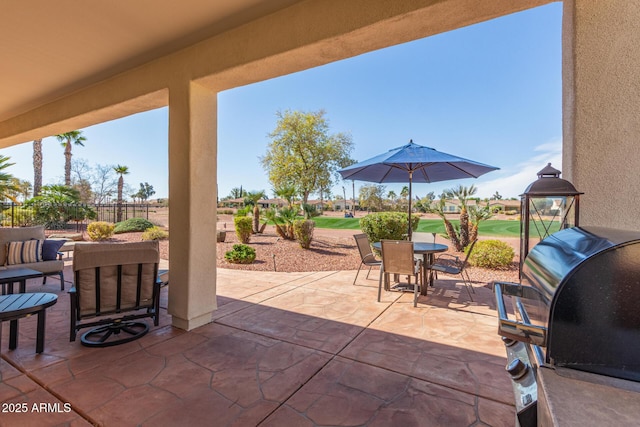 view of patio / terrace featuring outdoor dining space and fence