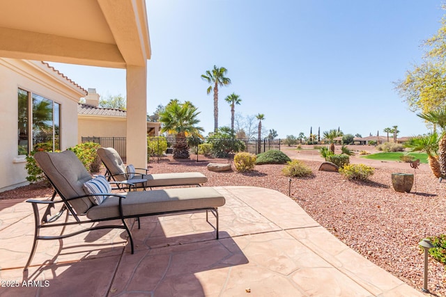 view of patio featuring fence