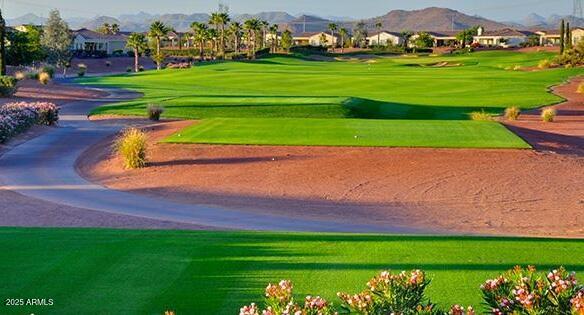 view of community with a yard and golf course view