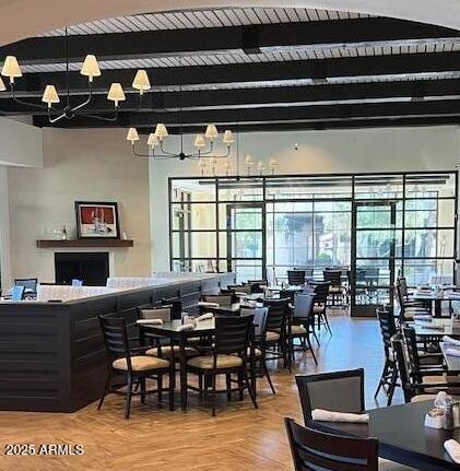 dining space featuring beam ceiling, wooden ceiling, and a notable chandelier