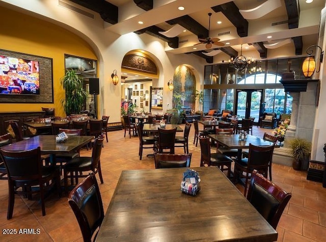 tiled dining room featuring arched walkways, beam ceiling, and recessed lighting