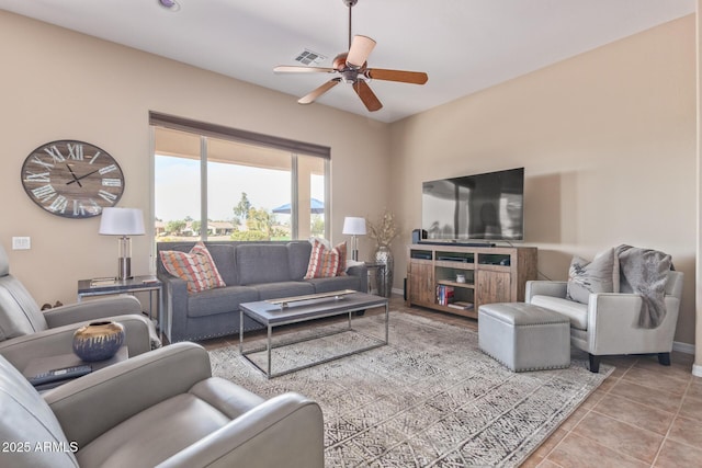 living room with visible vents, ceiling fan, baseboards, and tile patterned floors