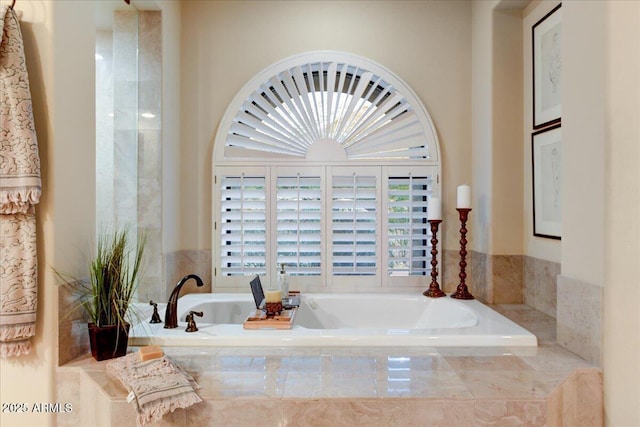 bathroom with tiled bath