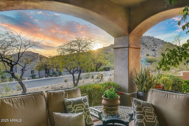 balcony at dusk with a mountain view and outdoor lounge area