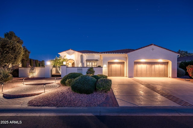 mediterranean / spanish house with a garage