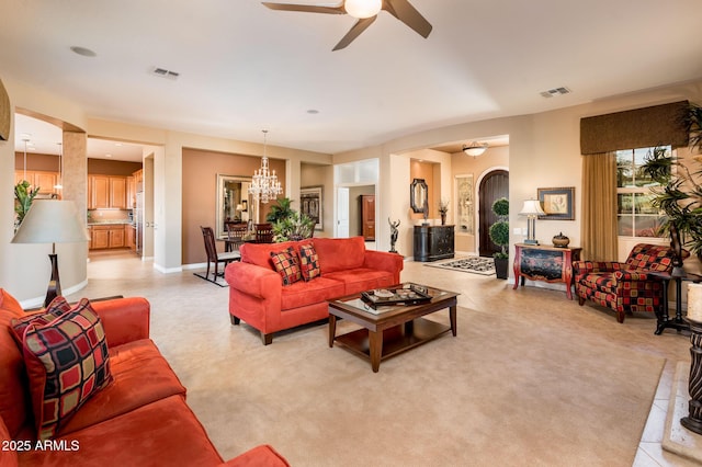 living room with ceiling fan with notable chandelier