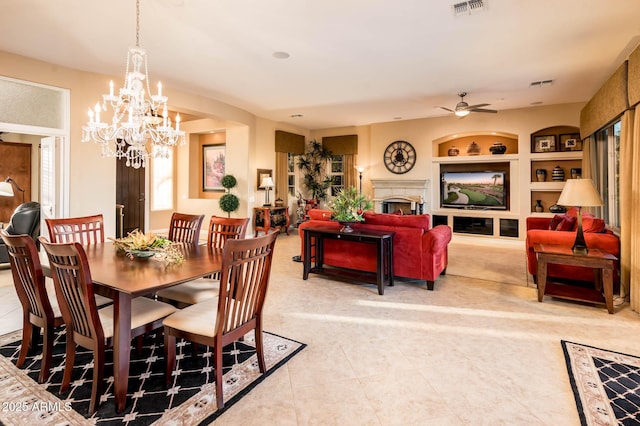 tiled dining area featuring built in shelves and ceiling fan