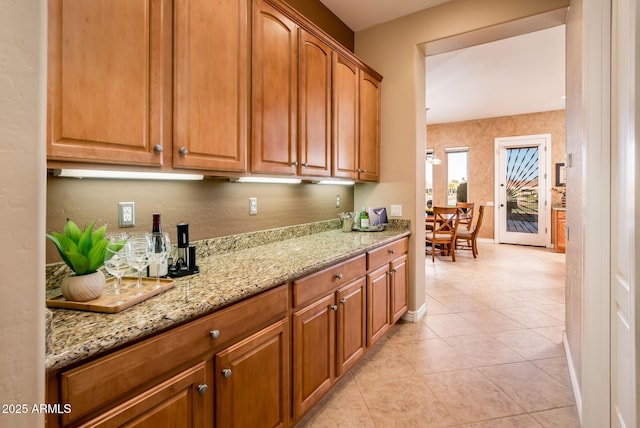 kitchen with light stone countertops and light tile patterned floors