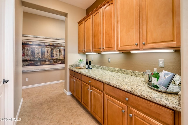 kitchen featuring light stone counters and light tile patterned floors