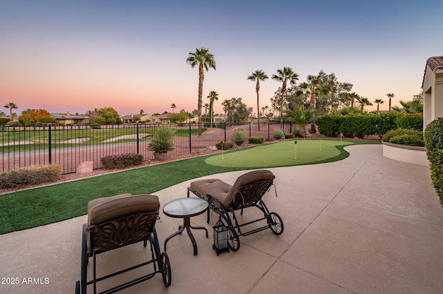 patio terrace at dusk featuring a water view