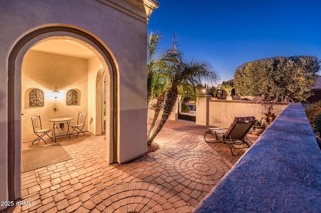 view of patio terrace at dusk