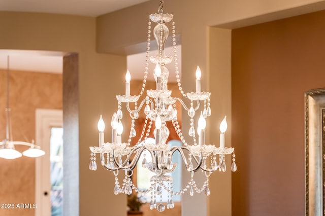 interior details featuring an inviting chandelier