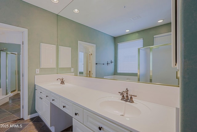 full bathroom featuring double vanity, a sink, recessed lighting, and a shower stall