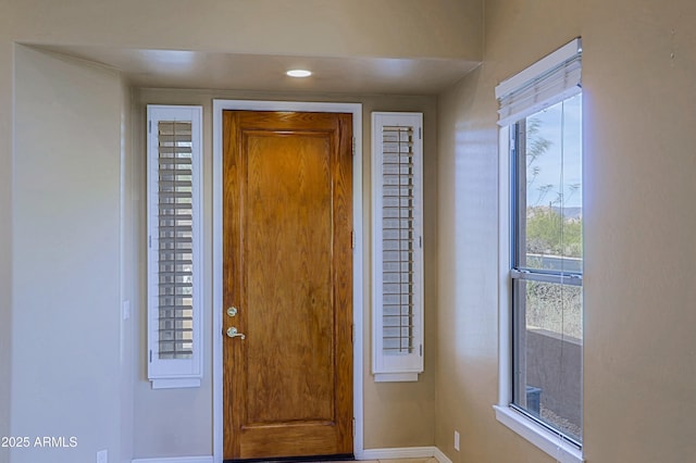 foyer featuring baseboards