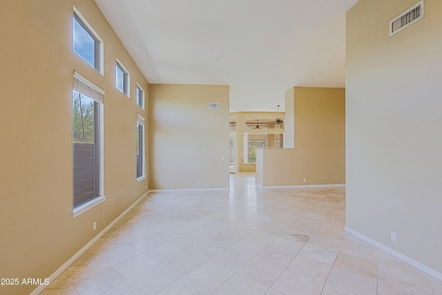 spare room with baseboards and visible vents