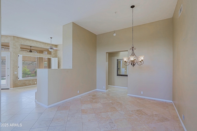 unfurnished room with baseboards, visible vents, and an inviting chandelier