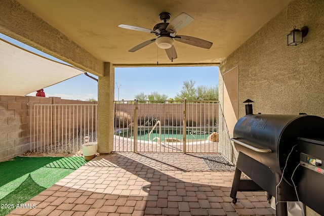 view of patio / terrace with a ceiling fan, a fenced backyard, and a grill