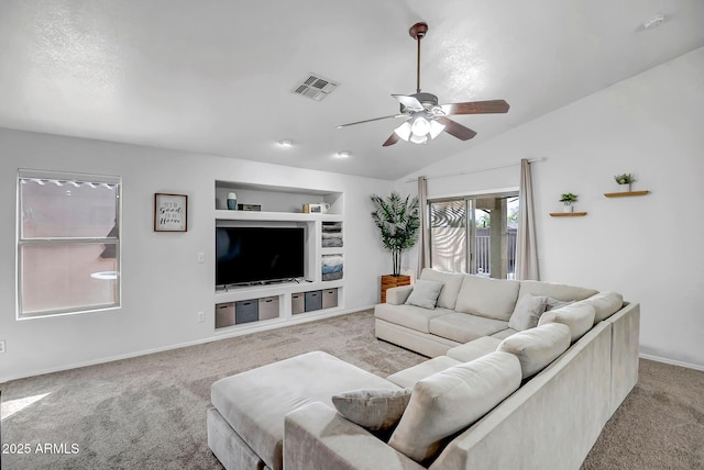 carpeted living area with visible vents, baseboards, built in features, vaulted ceiling, and a ceiling fan