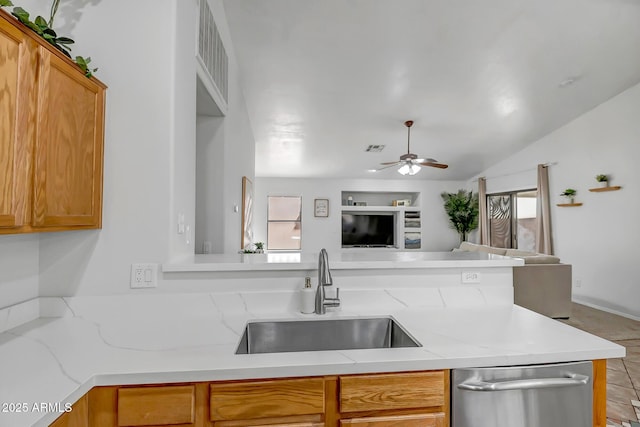 kitchen with a ceiling fan, visible vents, a sink, stainless steel dishwasher, and open floor plan