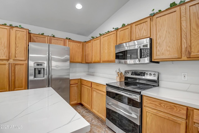 kitchen with vaulted ceiling, light tile patterned flooring, recessed lighting, and appliances with stainless steel finishes