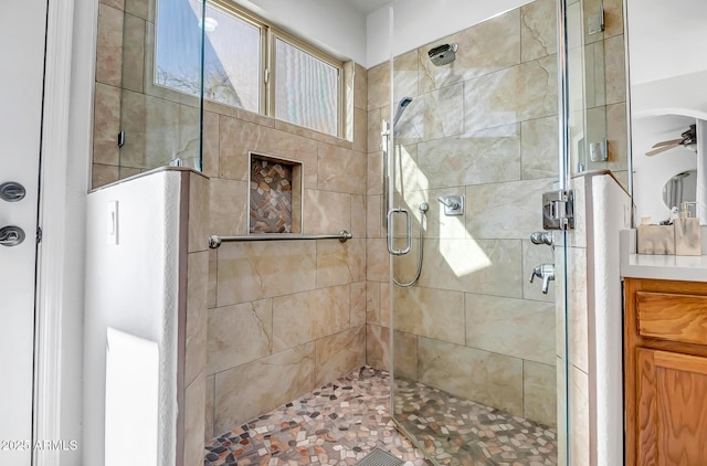 bathroom featuring vanity, a stall shower, and ceiling fan