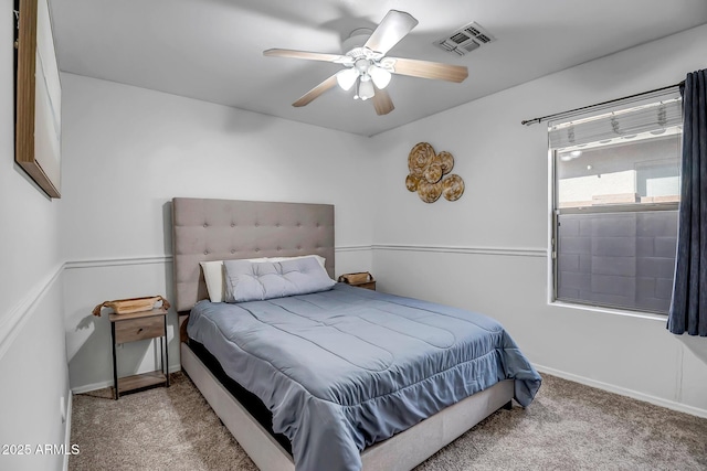 bedroom featuring baseboards, visible vents, carpet floors, and ceiling fan