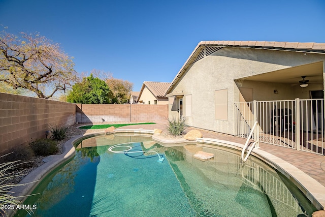 view of swimming pool featuring a patio area, a ceiling fan, a fenced in pool, and a fenced backyard