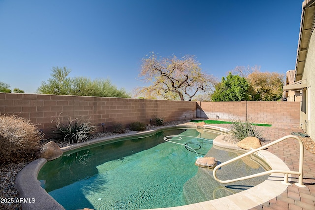 view of pool with a fenced in pool, a fenced backyard, and a patio area