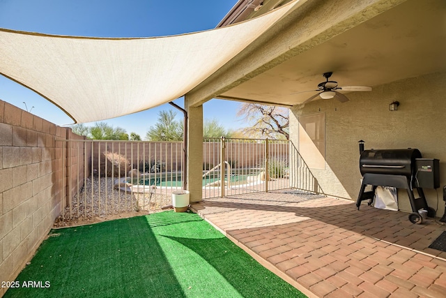 view of patio / terrace featuring ceiling fan, a fenced in pool, a grill, and a fenced backyard