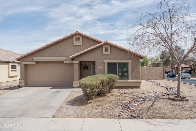 2889 S 161st Dr, Goodyear, AZ 85338 - view of front of house with fence, a tile roof, concrete driveway, stucco siding, and an attached garage