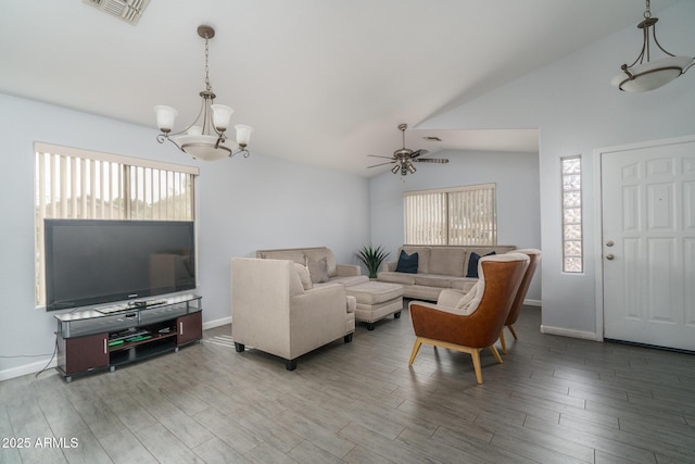 2889 S 161st Dr, Goodyear, AZ 85338 - living area featuring visible vents, light wood finished floors, baseboards, vaulted ceiling, and ceiling fan with notable chandelier