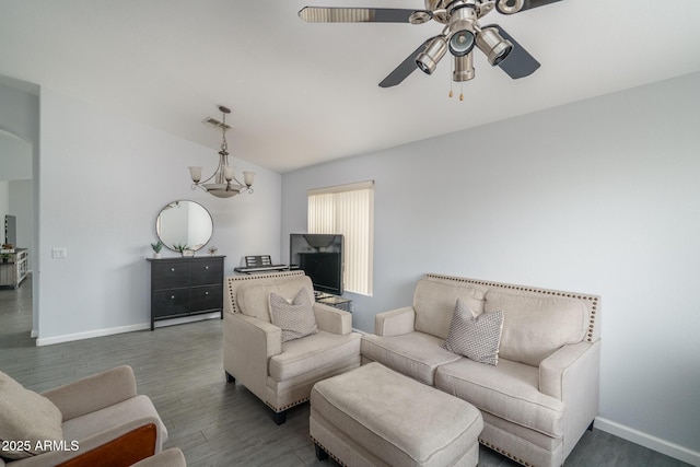 2889 S 161st Dr, Goodyear, AZ 85338 - living area with wood finished floors, visible vents, baseboards, arched walkways, and ceiling fan with notable chandelier