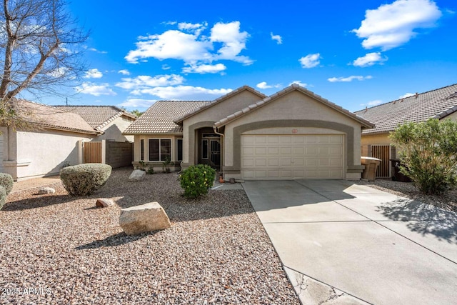 ranch-style home featuring a tile roof, driveway, an attached garage, and stucco siding