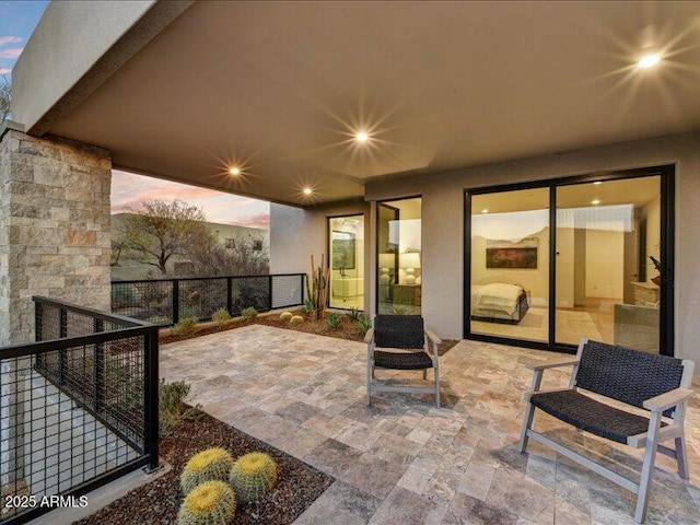 view of patio terrace at dusk