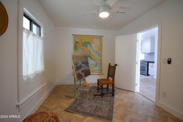 living area featuring light parquet floors and ceiling fan