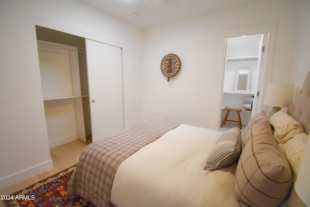 bedroom with a closet and light hardwood / wood-style floors