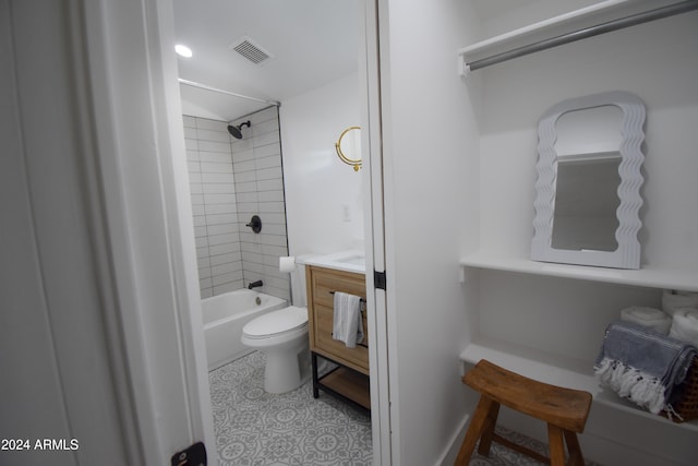 full bathroom featuring toilet, tiled shower / bath, and vanity