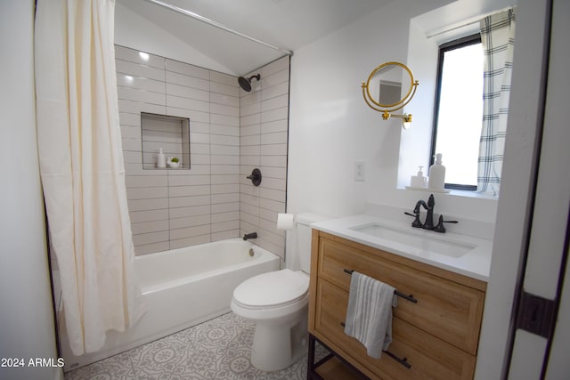 full bathroom with vanity, shower / tub combo with curtain, toilet, and vaulted ceiling