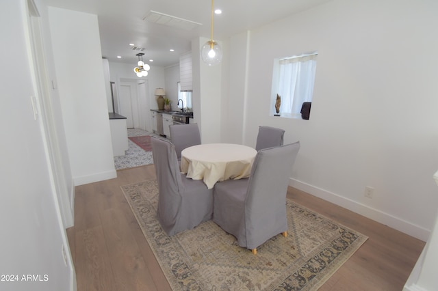 dining room featuring sink and light hardwood / wood-style floors