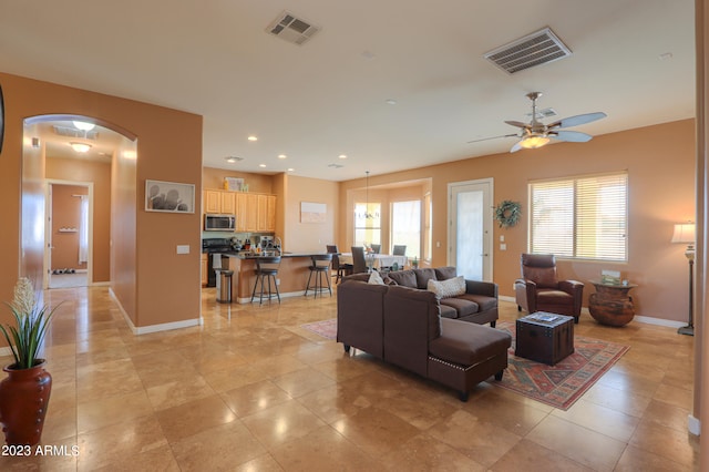 living room with a wealth of natural light and ceiling fan