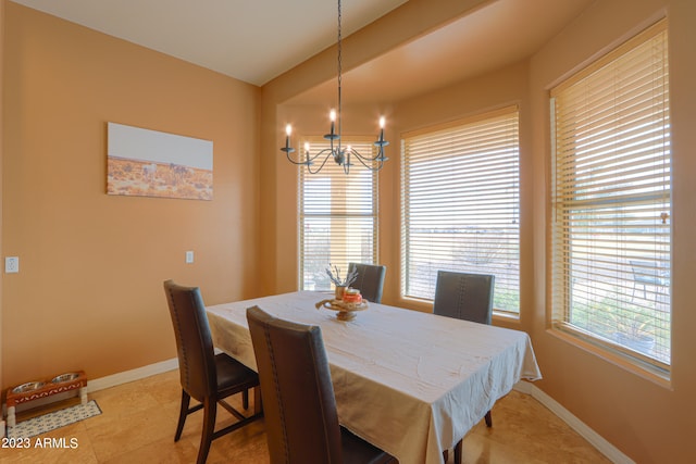 dining area featuring light tile patterned floors and a chandelier