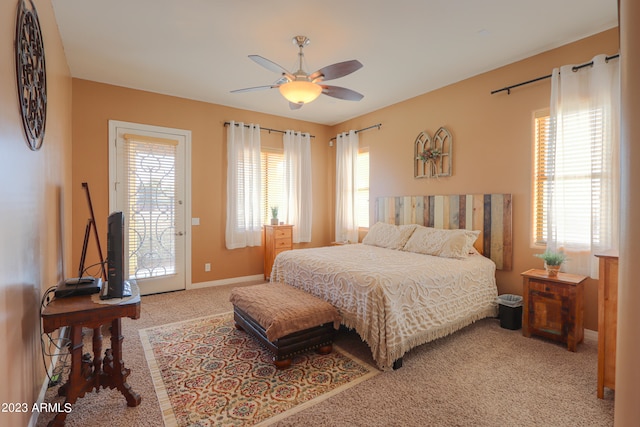 bedroom featuring ceiling fan, access to exterior, carpet floors, and multiple windows