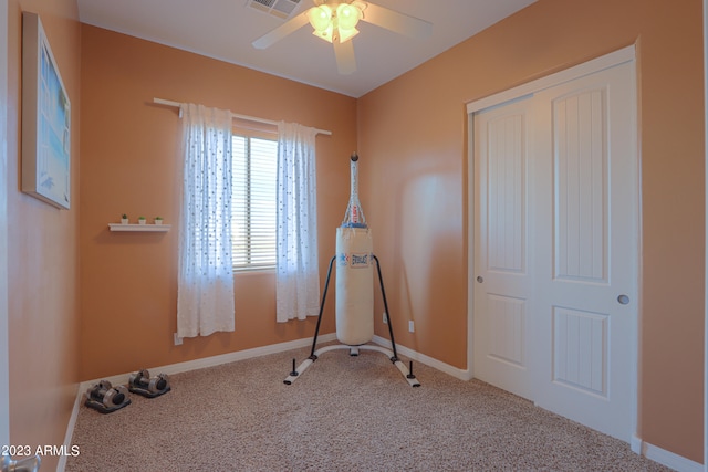 exercise room featuring carpet and ceiling fan