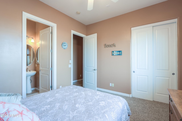 bedroom with carpet floors, a closet, ensuite bath, and ceiling fan